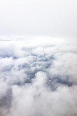 Isolated sky cloudscape with fluffy cloud and soft fog mist on aerial high angle vertical view of from airplane