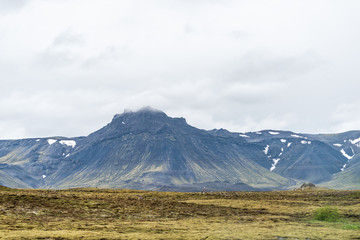 Fototapeta premium Iceland landscape view of mountain on cloudy day on south southern ring road or golden circle with power lines