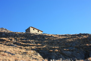 old ancient structure or abandoned and now disused building on the mountains