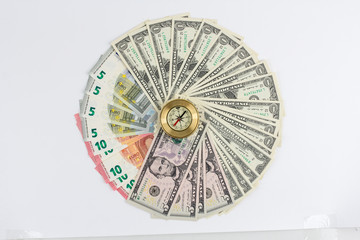 Banknotes dollars and euros are fan in a circle on a white backg