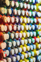 Fototapeta premium many cans of paint with lids lined in a row