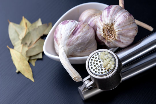 Fresh and healthy garlic on a black kitchen table. A healthy natural antibiotic for colds.