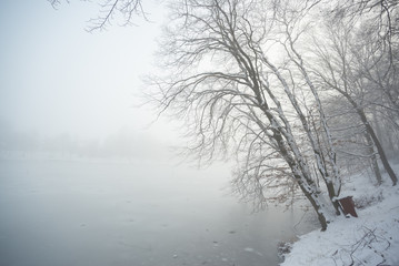 Winter frozen lake in fog