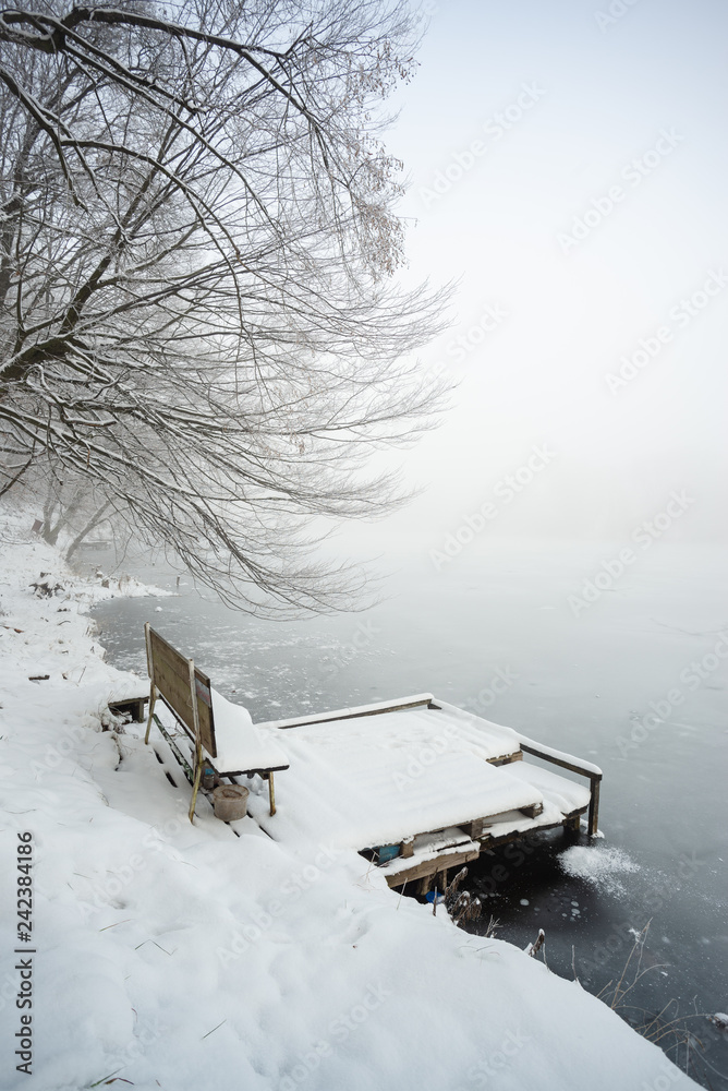 Poster Pier on frozen winter lake in the fog