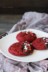Cookies red velvet in chocolate glaze with the decor of sugar hearts