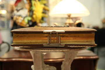 Old album with gold pages on vintage lamp background