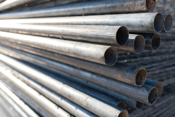 Stack of steel pipes for the construction of scaffolding.