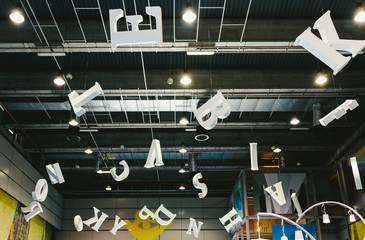 Valencia, Spain - December 4, 2019: Giant letters hanging from the roof of a fairground.