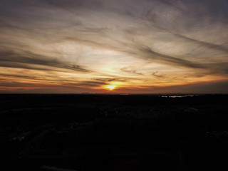 Fototapeta na wymiar sunset behind clouds with city skyline
