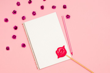 a notebook to record a message for Valentine's day. copy space. pencil, kiss, lips