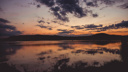 Obraz premium Fishing lake at sunset - view from tent
