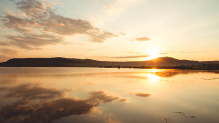 Fototapeta na wymiar Fishing lake at sunset - view from tent