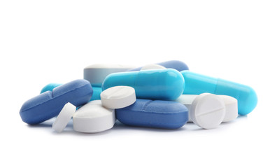 Pile of different pills on white background