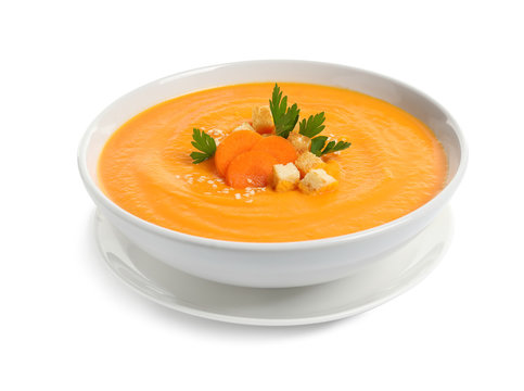 Dish with carrot cream soup on white background. Healthy food