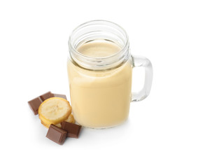 Mason jar with protein shake and ingredients on white background