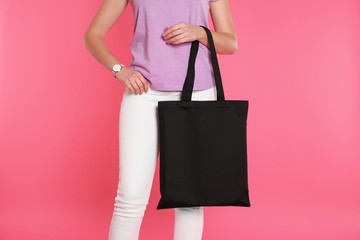 Woman with eco bag on color background. Mock up for design