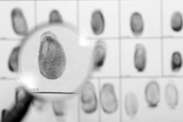 Criminal fingerprint card and magnifier, top view. Space for text
