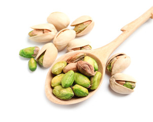 Organic pistachio nuts and spoon on white background, closeup