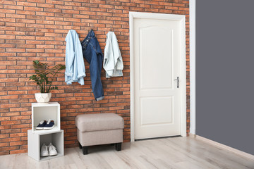 Stylish hallway interior with door and comfortable furniture - obrazy, fototapety, plakaty