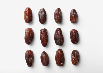 Sweet dates on white background, top view. Dried fruit as healthy snack