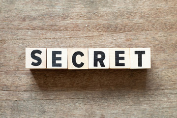 Fototapeta premium Letter block in word secret on wood background