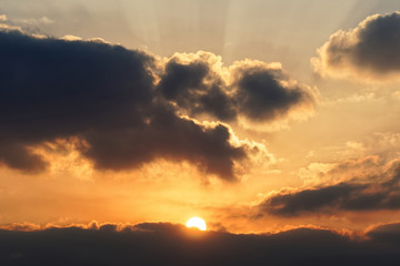 Bright big sun on the sky with yellow orange gradient colors, beautiful sunset cloudy sky.