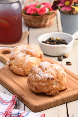 Delicious cream puffs on a cutting board