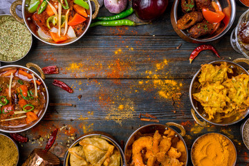 Assorted indian food set on wooden background. Dishes and appetisers of indeed cuisine, rice,...