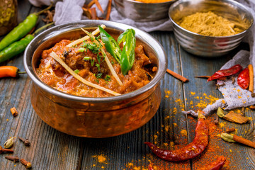 chicken tikka masala Indian food on wooden background with spices