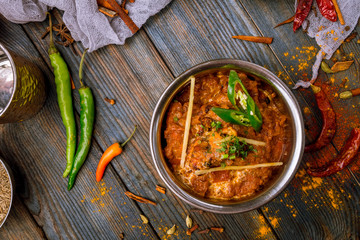 chicken tikka masala Indian food on wooden background with spices