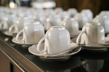 group of cleaned white cup of coffee with spoon on table, ready to use
