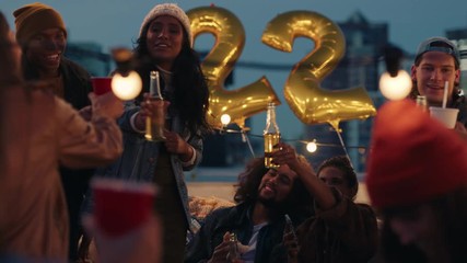 happy group of friends celebrating birthday party on rooftop at sunset beautiful young enjoying celebration making toast to friendship 