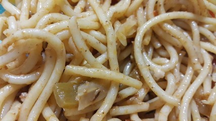 close up view of swirling noodles or spaghetti pasta in a bowl