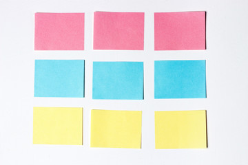 Mock-up of many empty multicolored office stickers on a wooden background. Copy space, space for text. Office concept