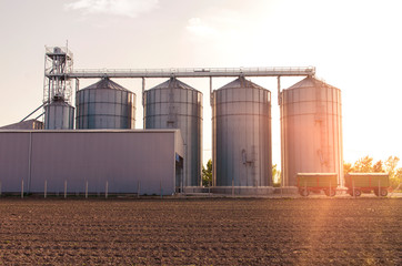 Agricultural silos for soy and  grains sunset shot , trailers in front of object © phoenix021