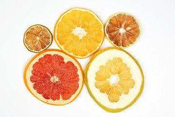 Dried slices of various citrus fruits closeup on white background