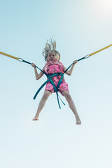 The girl flies up on the attraction very much frightened.