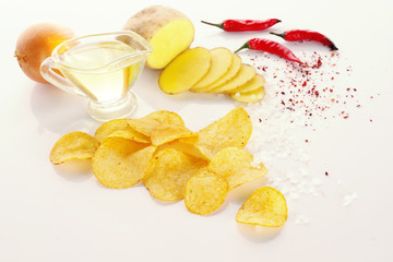 Fototapeta na wymiar Potato chips and ingredients on a white background.
