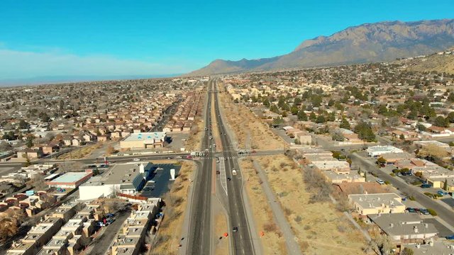 Aerial shot showing a bridge with cars moving below it and then panning up to review the northeast parts of the city.