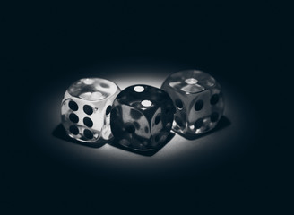 Multi color dice shinning in the dark by soft light