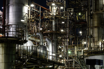 Column tower in petrochemical plant at night