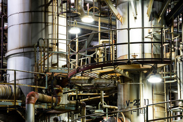 Column tower in petrochemical plant at night