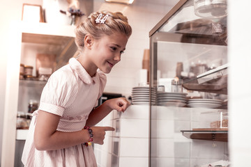 Happy delighted girl looking at the display