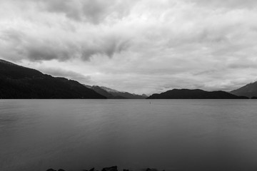 morning on beautiful Harrison lake with mountain background and cloudy sky.