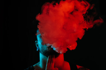 Guy blowing a lot of smoke out of his mouth.