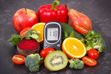 Glucometer for checking sugar level with fruits and vegetables containing vitamins, healthy eating for diabetic