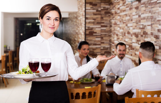 Female waiter showing country restaurant