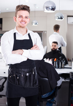 male hairdresser showing his workplace and tools at hair salon
