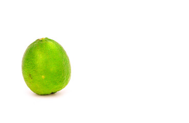 A green lemon isolated on white background .