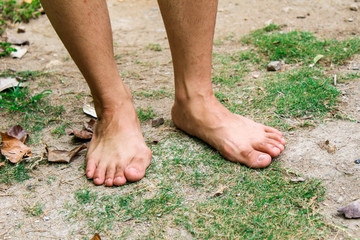 Fototapeta na wymiar Bare feet of woman standing on the ground.